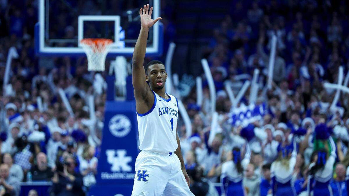 Kentucky guard Lamont Butler makes a first-half 3-pointer during the Wildcats’ win against archrival Louisville on Saturday at Rupp Arena.