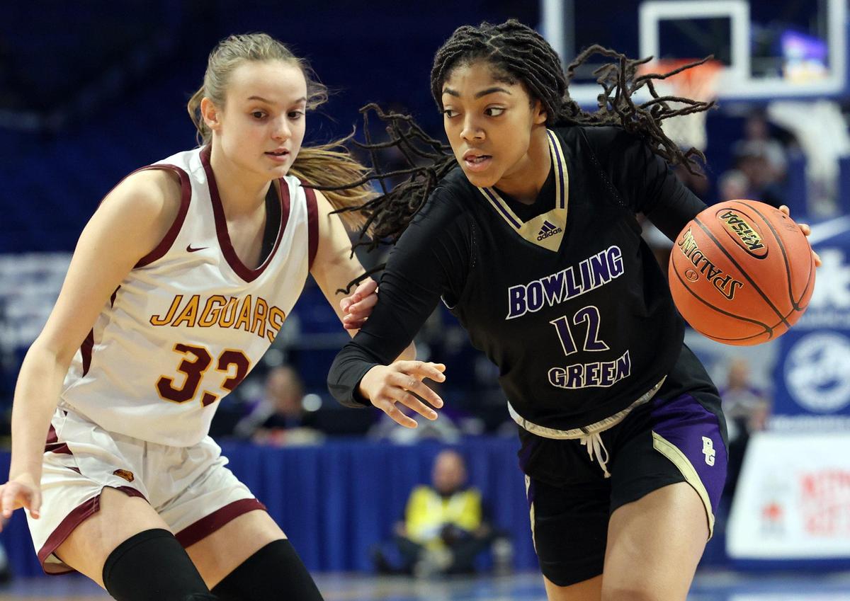 Bowling Green’s Tanaya Bailey (12) drives on Cooper’s Logan Luebbers Palmer (33) on Friday night.