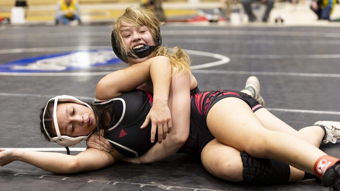 Boyle County’s Lyla Smith, right, battled her chin strap and McCreary Central’s Allissa Chinas-Rodriguez in the 120-pound finals of the 2026 KHSAA Girls State Wrestling Championships at the Kentucky Horse Park’s Alltech Arena on Saturday.