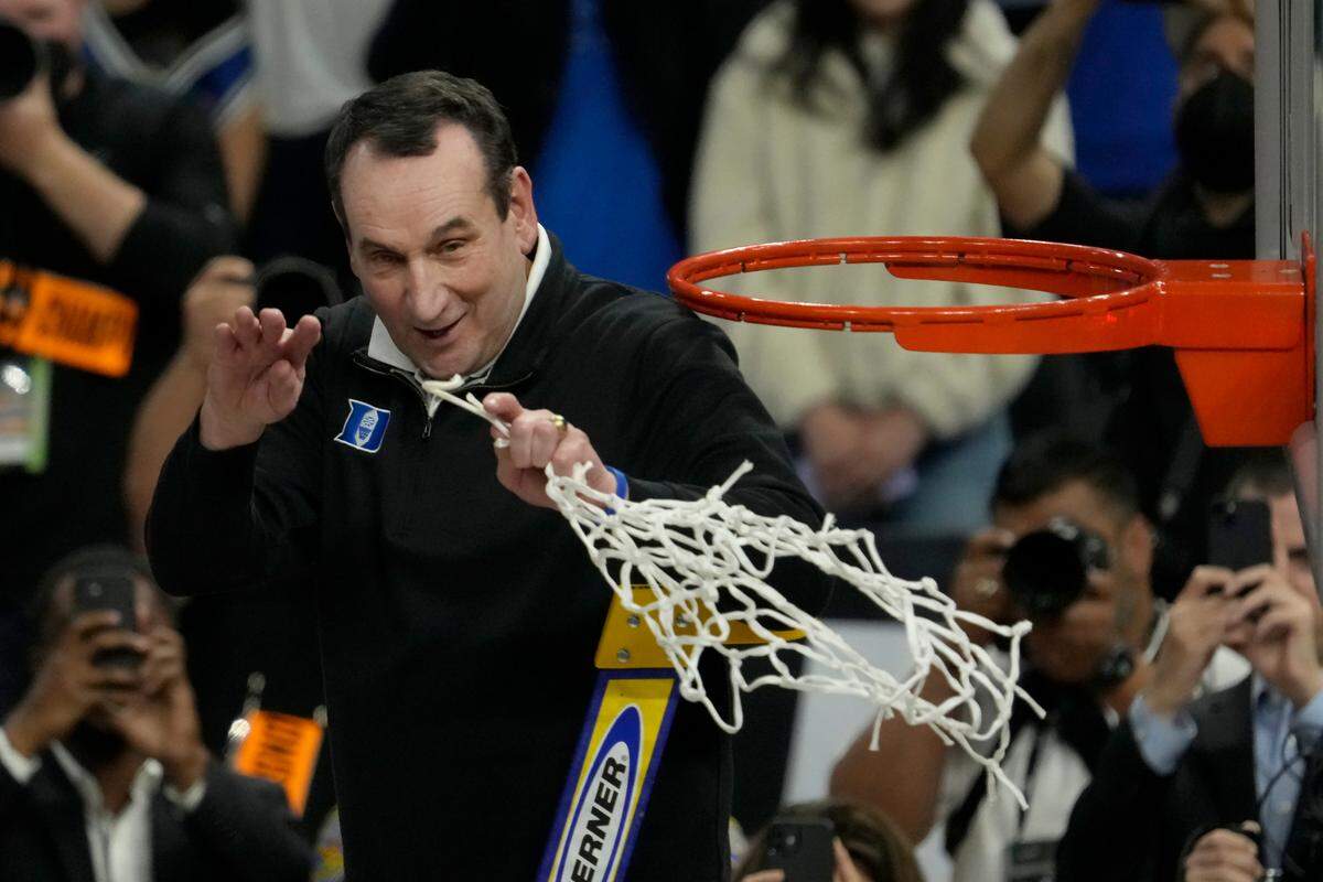 Duke head coach Mike Krzyzewski celebrates while cutting down the net after Duke defeated Arkansas in a college basketball game in the Elite 8 round of the NCAA men’s tournament in San Francisco, Saturday, March 26, 2022. (AP Photo/Tony Avelar)