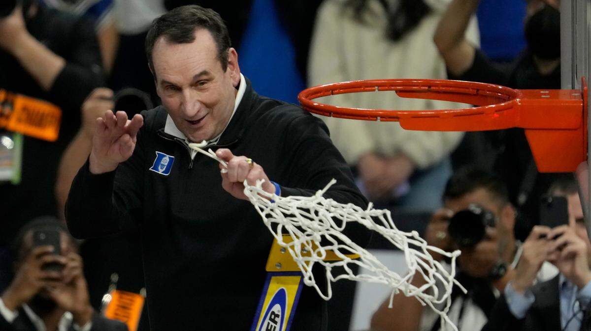 Duke head coach Mike Krzyzewski celebrates while cutting down the net after Duke defeated Arkansas in a college basketball game in the Elite 8 round of the NCAA men’s tournament in San Francisco, Saturday, March 26, 2022. (AP Photo/Tony Avelar)
