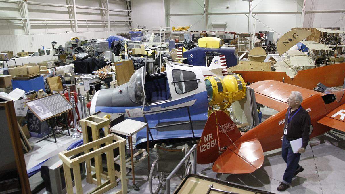 Aviation Museum of Kentucky board member Frank Peters walked among the exhibits that have been moved from the museum's old location and that will be  reassembled for display in its new home, the former TAC Air facilities at Blue Grass Airport.   