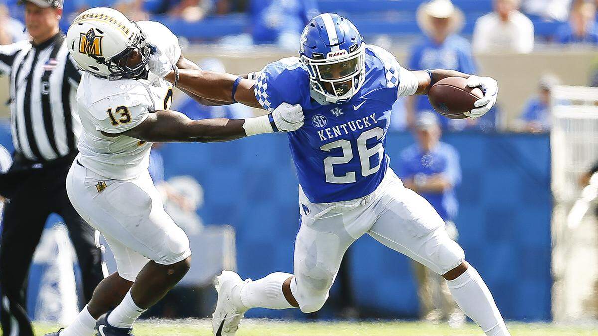 Kentucky running back Benny Snell Jr. (26) threw a stiff arm at Murray State linebacker Quincy Williams (13) during the Wildcats’ win at Kroger Field on Saturday.