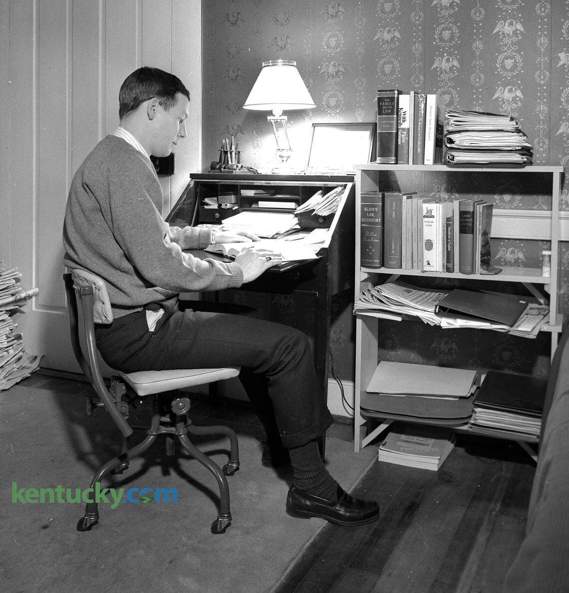 Sen. Mitch McConnell, in his third year in the College of Law at the University of Kentucky, in his Lexington apartment, January, 1967. McConnell shared a three-room apartment with Dan White, a candidate for a doctorate in English, on the second floor of a six-unit building at 337 South Mill St. The photo ran with a story on how their apartment building previously had a different front entrance when it was a house because it had faced a street that no longer existed. The story said McConnell was “chief cook” of the apartment he shared with White and that they met as eighth-graders at Manuel High School in Louisville. Both said an apartment in a more modern building might be easier to clean. “But then we don’t do much,” they admitted. “And this is the kind of home I’d like to own,” McConnell said. Their apartment was once the master bedroom for the house, which was built in 1816. The caption published with this photo said his desk is “like Linus’ blanket - it goes where he goes.” The books on the shelf next McConnell’s desk include “The Family and the Law,” “With Kennedy,” “The Making of the President, 1964,” Humor from Harper’s,” “Black’s Law Dictionary”, “Joy of Cooking,” The Anatomy of Liberty” and “Labor Relations and the Law.” McConnell, who was President of the student Bar Association, graduated with his law degree later that year. Published Sunday, Jan. 29, 1967 in the Sunday Herald-Leader.