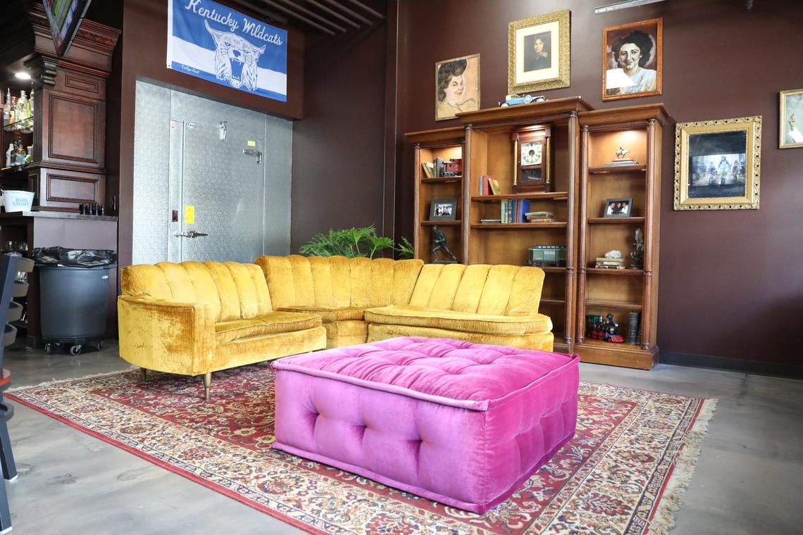 The lounge area near the “Blister wall” featuring beloved family portraits at 2 Fisted Willie’s.