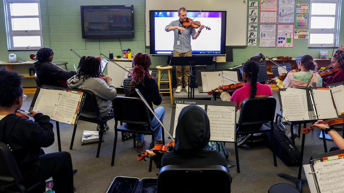 Teacher Dennis Bates instructs students playing the violin and viola during an orchestra class at Lexington Traditional Magnet School, March 4, 2025 in Lexington, Ky. The approximately 300 students in the school are enrolled in the Visual and Performing Arts Hub or Pathways program using arts to prepare students for high school.