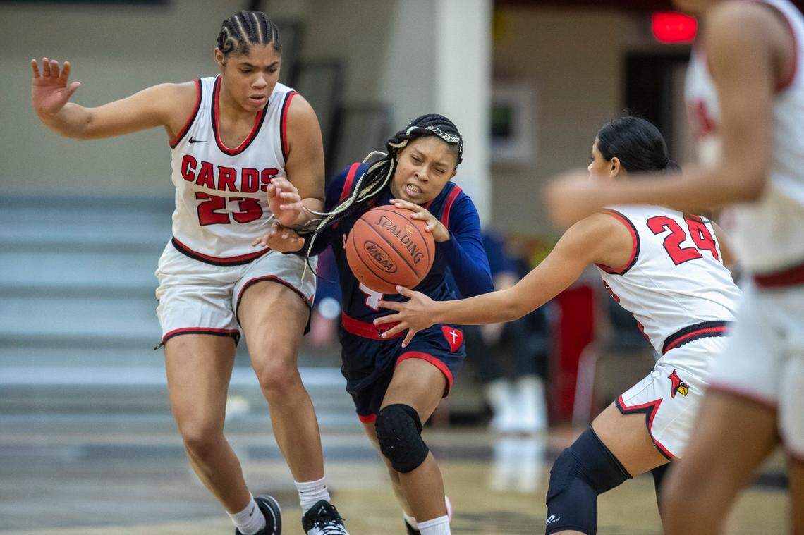 Sacred Heart’s Triniti Ralston, center, faces pressure from George Rogers Clark’s Brianna Byars (23) and Makili Tabor during a game in Winchester on Feb. 7.