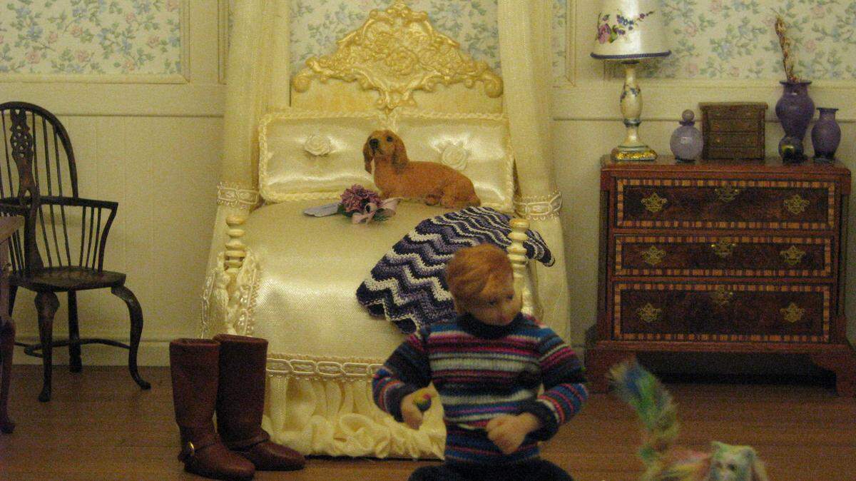 In one room of a contemporary dollhouse, a dachshund watches from atop a bed as the naughty Gregory dyes the cat. "It's important that all these stories are linked because it keeps you interested," Lori Kagan-Moore said.      