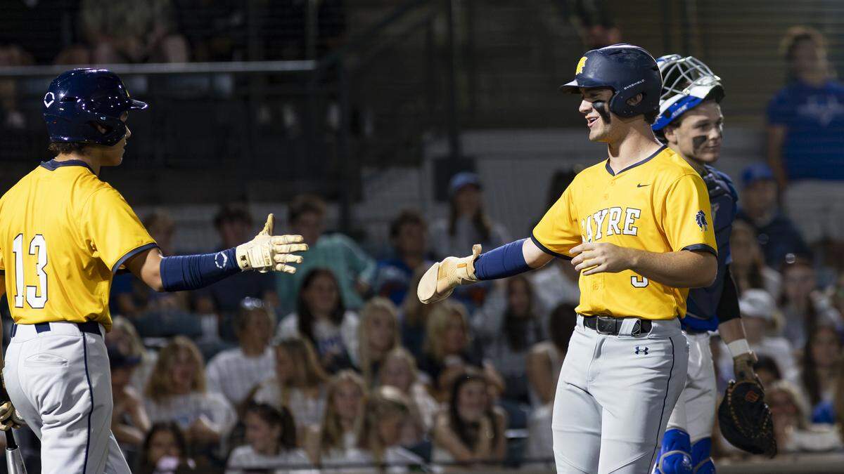 Sayre’s Gary Gibson (5) smiles as he approached teammate Joaquin Acevedo after crossing home plate with the go-ahead run in the seventh inning of the 11th Region Baseball Tournament quarterfinals on Monday at Legends Field.