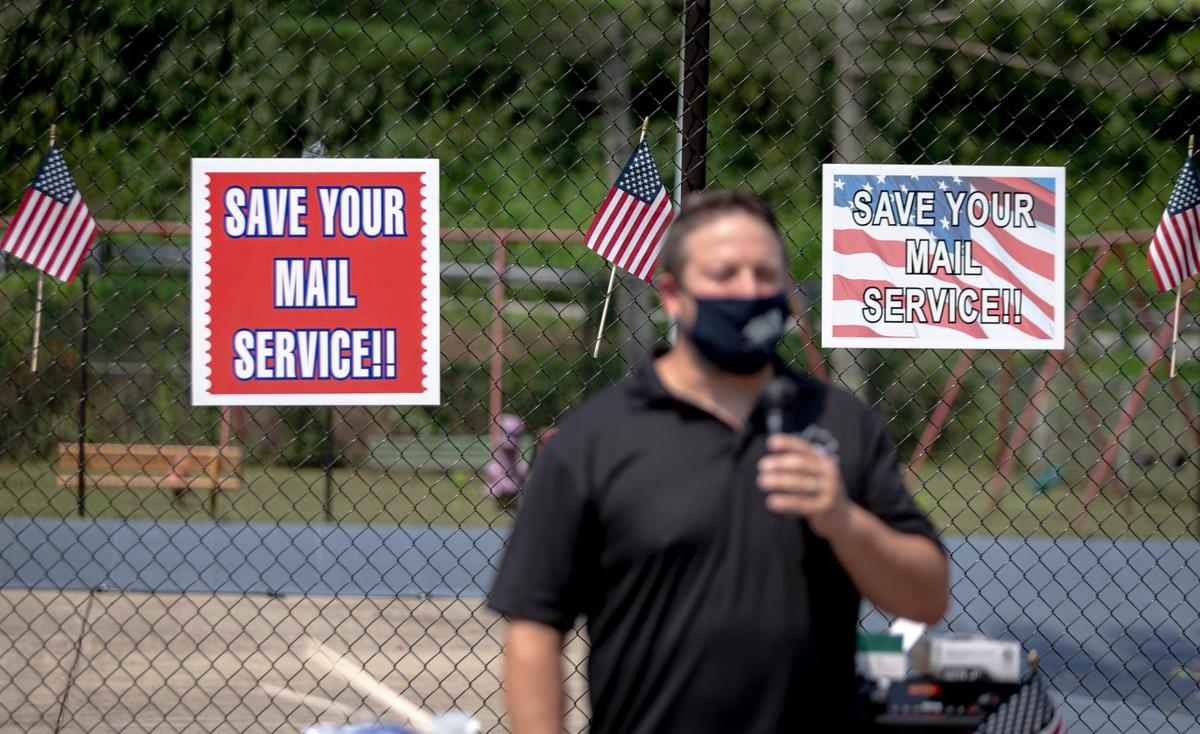Clyde Trent, Secretary of Kentucky Postal Workers Union, speaks to those gathered to participate in a car caravan down route 40 past Mike Duncan’s house and the Inez Bank, which is owned by Duncan, in Inez, Ky., Tuesday, August 25, 2020. “To all the elected officials, we have delivered for you all the years past, we have delivered for the IRS, now we are asking that you deliver for us,” Trent said. Among the demands mentioned was for $25 billion to be given to support the Postal Service and an end to the slowdown policies introduced by Postmaster Louis Dejoy.