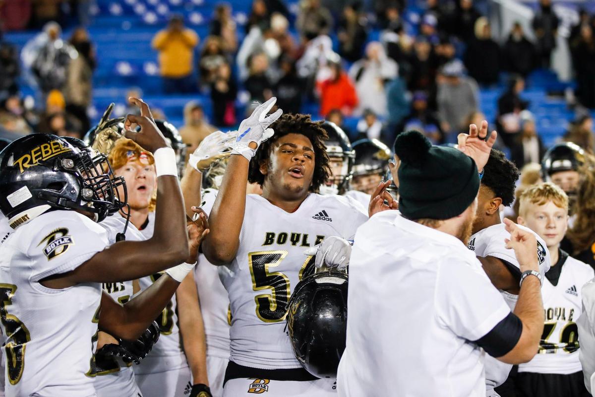 Boyle County’s Tommy Ziesmer (56) and his teammates celebrate the Rebels’ 32-26 three-peat win over Corbin in Class 4A state championship game at Kroger Field in Lexington on Friday night.
