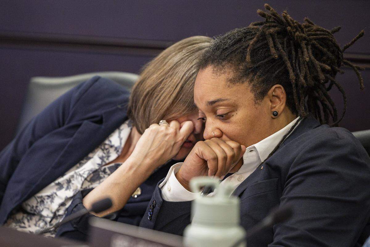 Rep. Sarah Stalker, left, whispers to Sen. Keturah Herron during an oversight hearing on Wednesday, July 30, 2025, at the Capitol Annex in Frankfort, Ky.