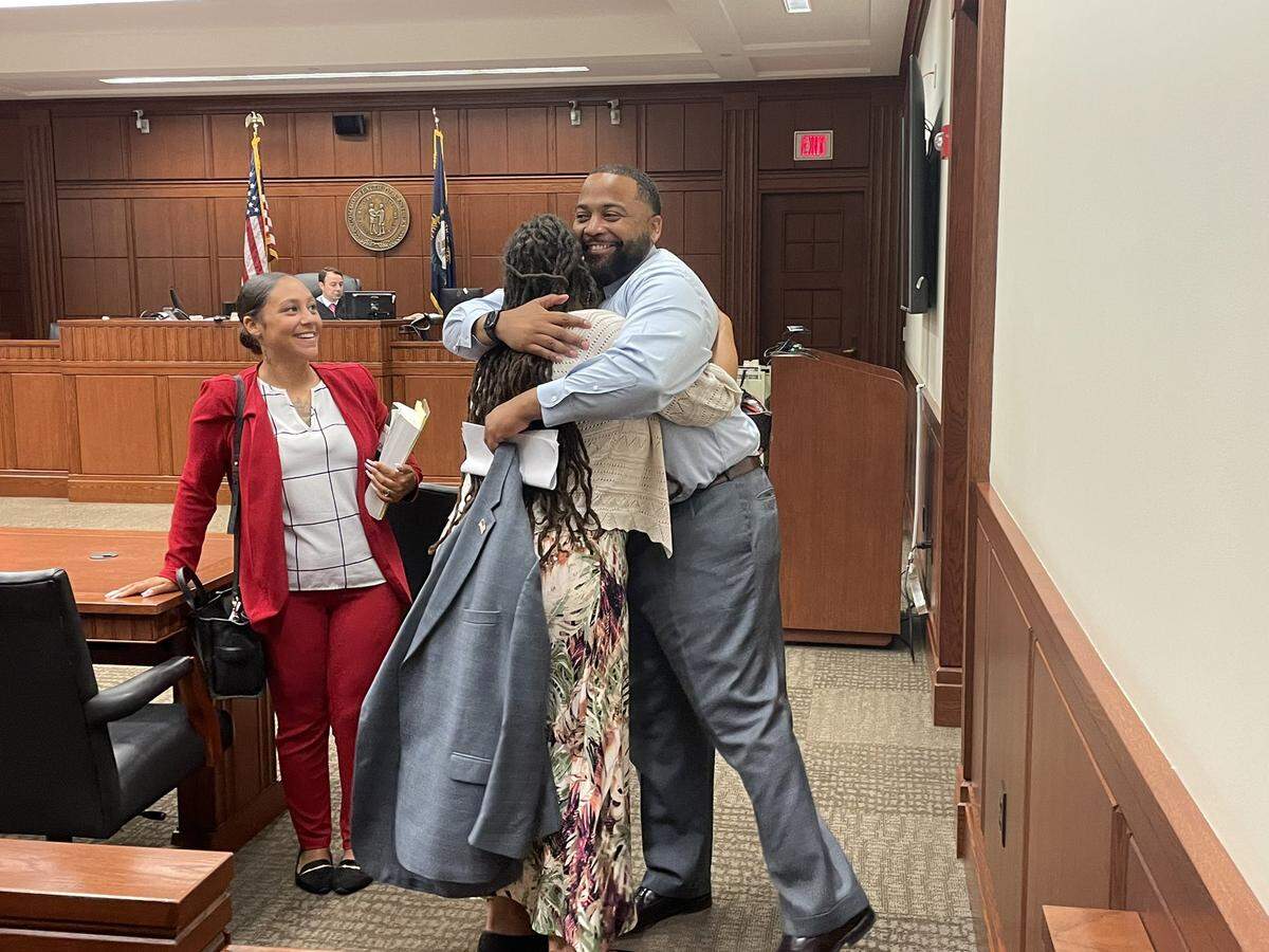 Sarah Williams hugs her attorney, Daniel Whitley, after she was acquitted on three of four charges in a trial that stemmed from her arrest at a racial justice protest in 2020.