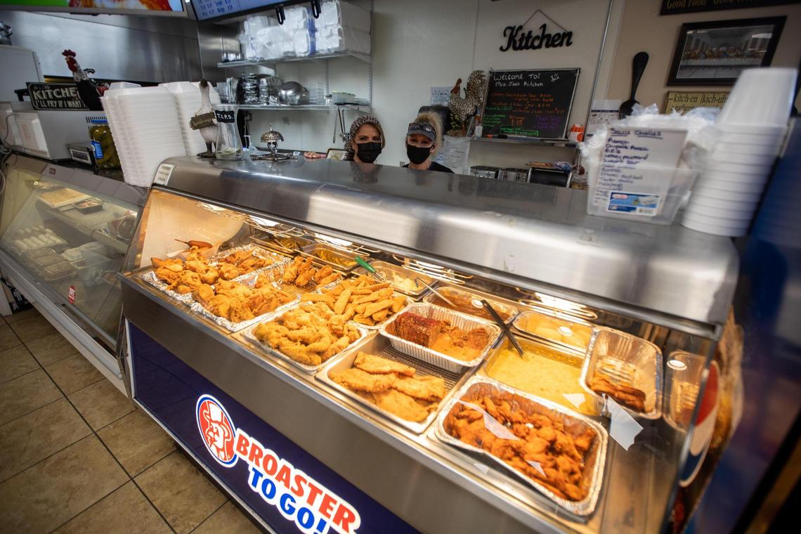 Joe’s Kitchen co-owner Rihab Rayyan, left, and lead cook Miranda Flannery, right, pose behind the food display within JoeÕs Mini Food Mart on East Loudon avenue, Feb. 12, 2021.