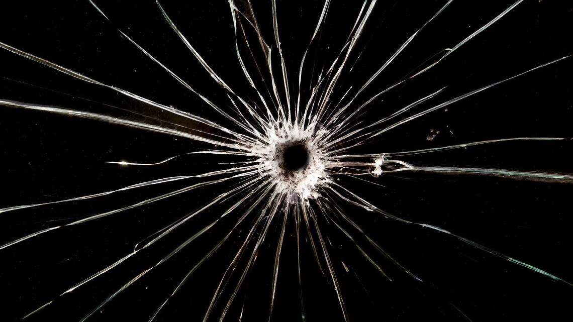 A bullet hole in glass.