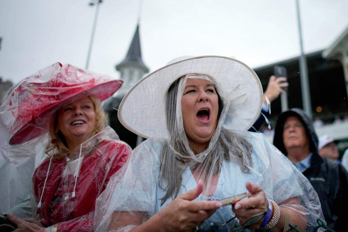 Spectators cheer during the first race of the day ahead of the 151th running of the Kentucky Derby at Churchill Downs.
