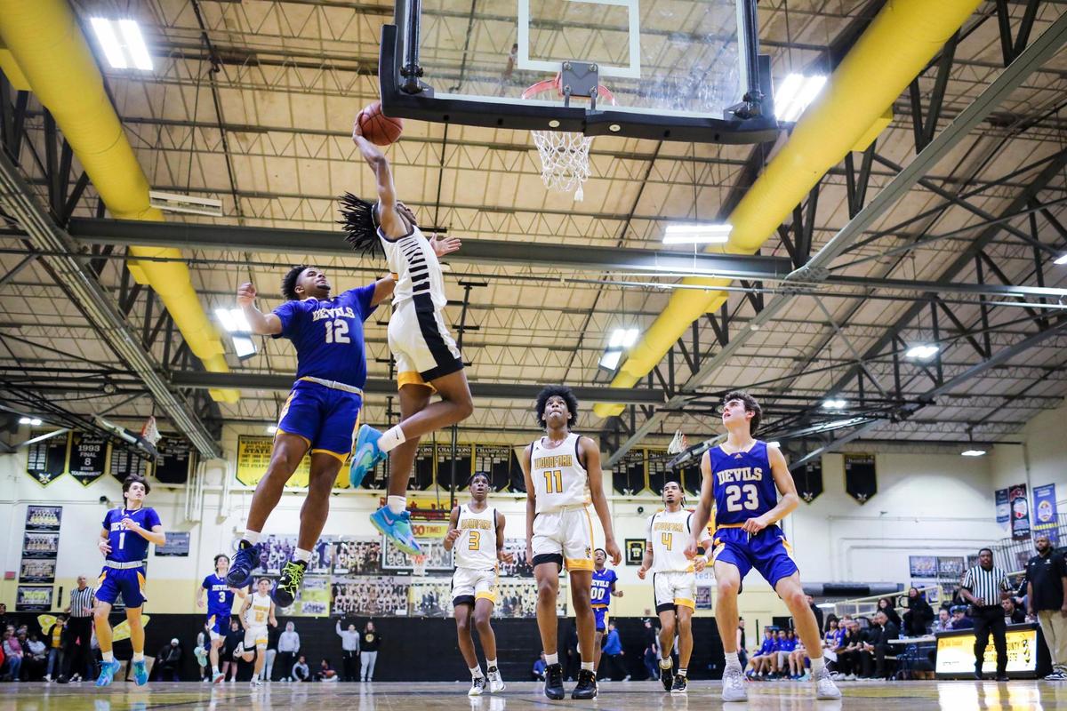 Woodford County’s Makhi Smith dunks for two of his 16 points during the Yellow Jackets’ win over Henry Clay on Thursday night in Versailles.