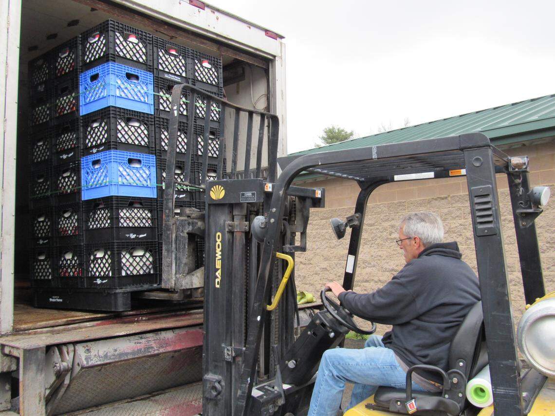 Roger Miller uses a forklift to unload crates of milk at God’s Food Pantry in Somerset, Ky., on March 23, 2020 to be given to people in need.