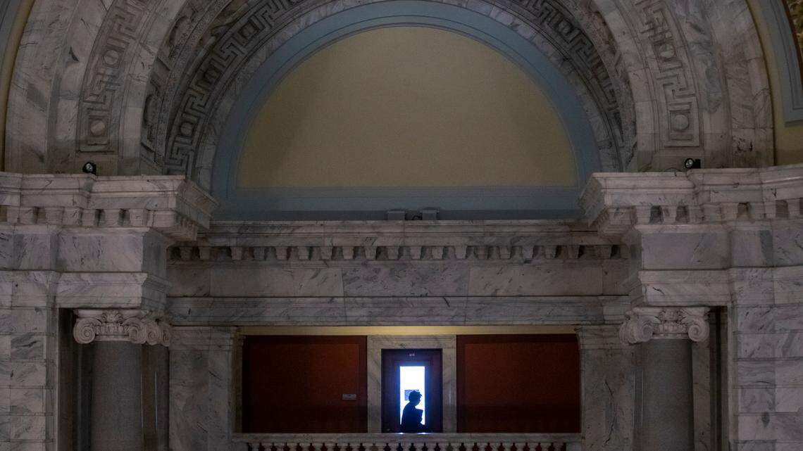 A woman walks through the Capitol on the last day of legislation at the Capitol in Frankfort, Ky., Thursday, March 30, 2022.