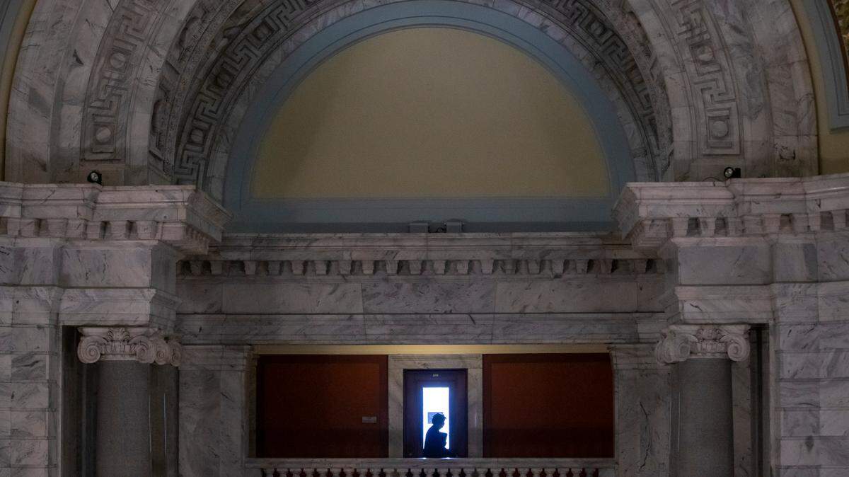 A woman walks through the Capitol in Frankfort, Ky., Thursday, March 30, 2022.