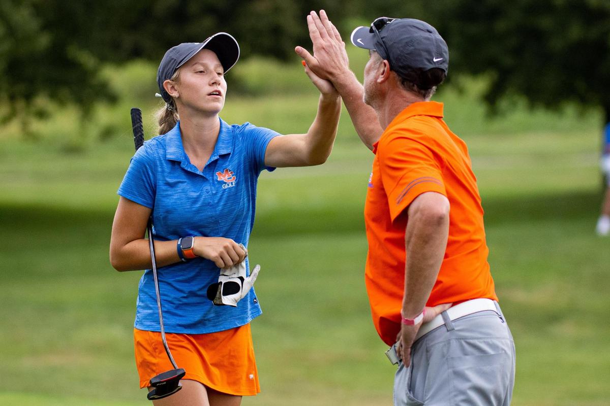 Marshall County’s Trinity Beth high fives her coach after making a putt during the KGCA All-State Championships on Sept. 19, 2021, at the University Club of Kentucky.