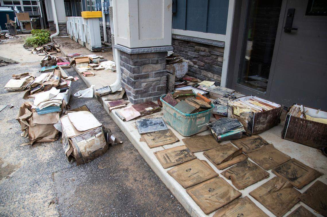 Salvaged historical documents and archives from the basement of the Hindman Settlement School lay on the sidewalk to dry after historic flooding damaged the entire first floor in the building in Hindman, Ky., Saturday, July 30, 2022.