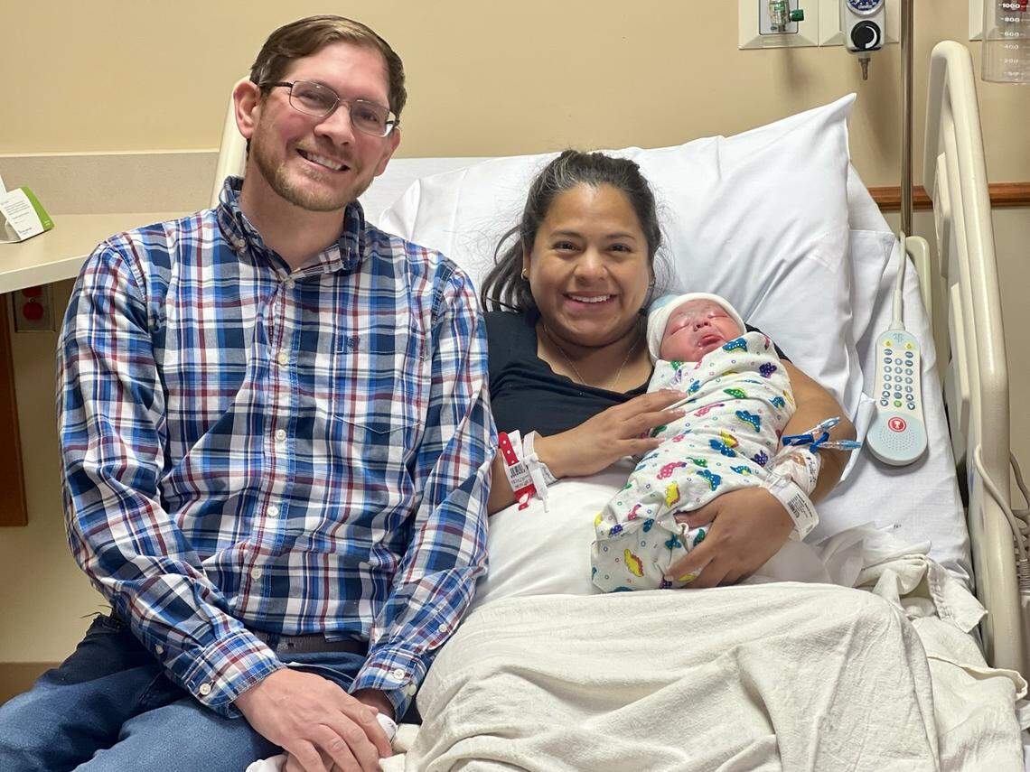 Rosa and Justin Westhoff pose for a photo with their newborn son, Tobias. Tobias was the first baby born in Lexington in 2025.