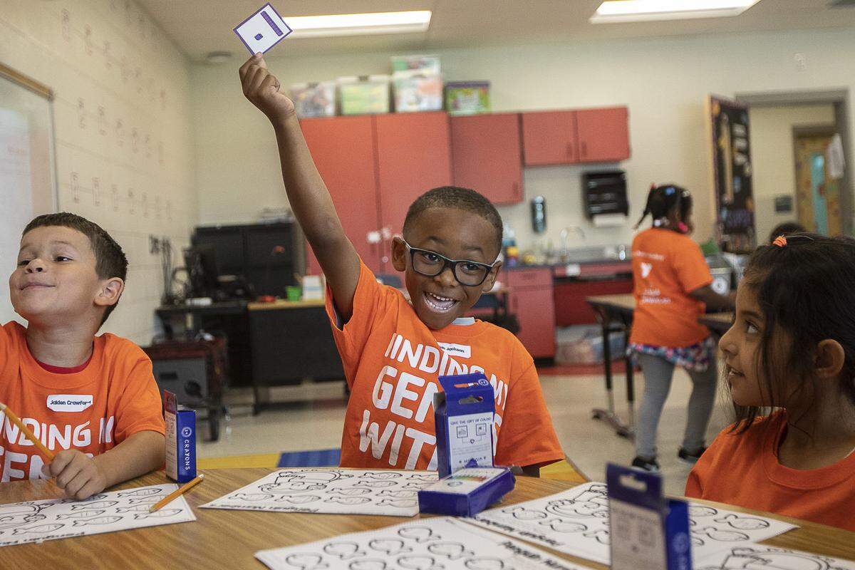 Elijah Jackson, a rising first-grade student, holds up a card while practicing number skills during the YMCA of Central Kentucky’s Power Scholars Academy at Coventry Oak Elementary School in Lexington, Ky., Wednesday, June 19, 2019.