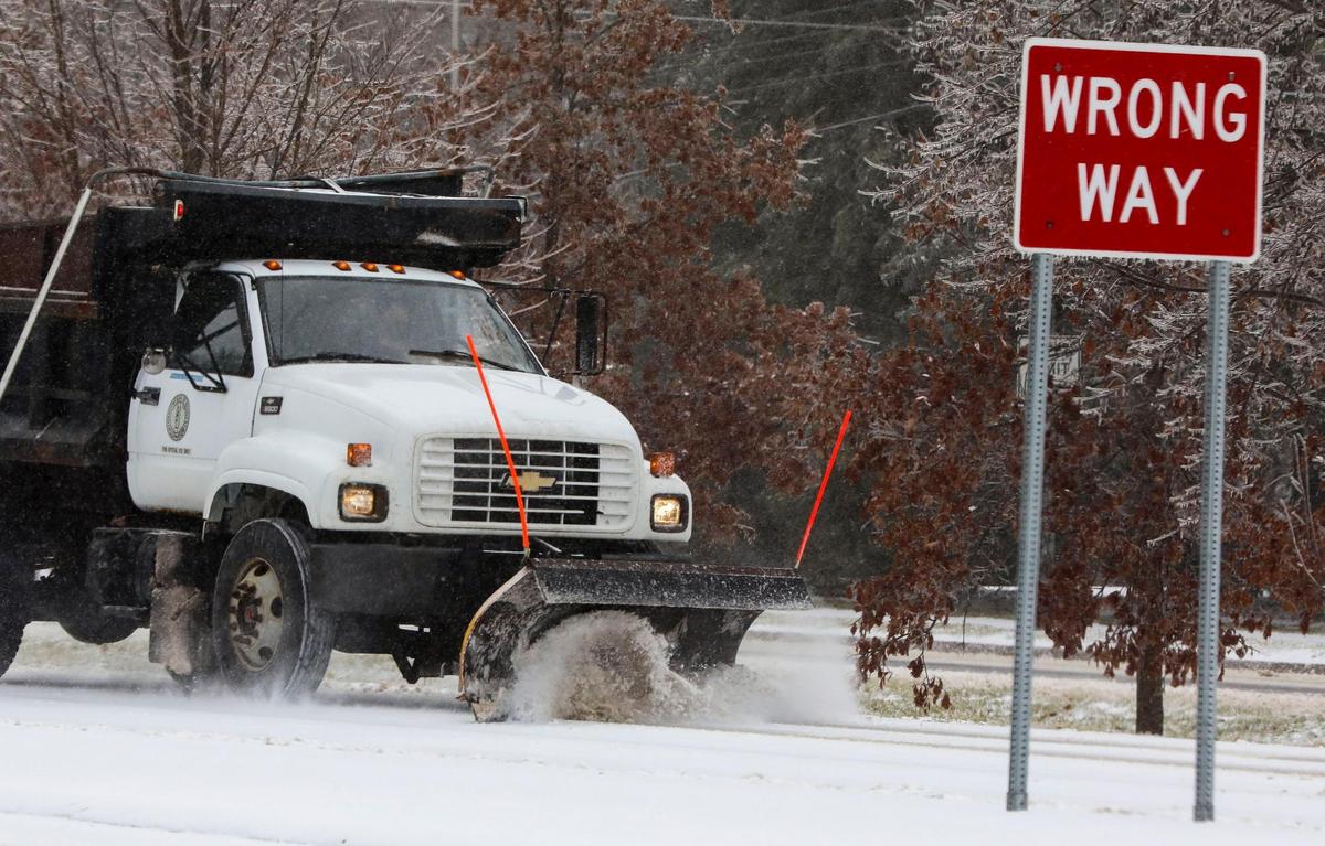 A Kentucky Department of Transportation snow plow clears Tates Creek Road at Alumni Drive in Lexington, Ky. Friday morning, Feb. 4, 2022 after an overnight winter storm of ice, sleet and snow blanketed the city.