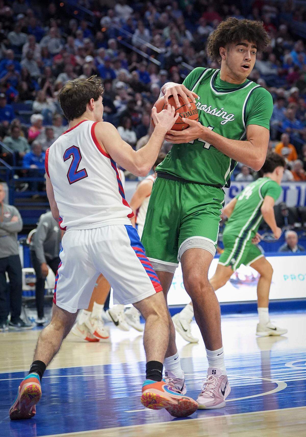 Montgomery County senior Cayden Reed, left, and Great Crossing senior Malachi Moreno battle for the ball during the Boys’ Sweet 16 semifinals at Rupp Arena on Saturday.