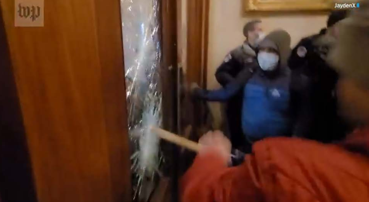 According to an FBI statement, this photo shows Chad Barrett Jones of Kentucky trying to smash the glass in a door in the U.S. Capitol building during the insurrection on Jan. 6, 2021.