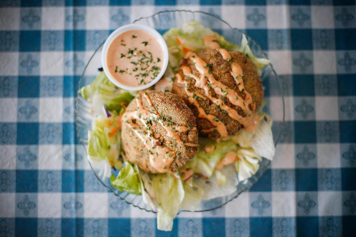Housemade crab cakes served with remoulade and garnished with cilantro at Jim’s Seafood in Frankfort.
