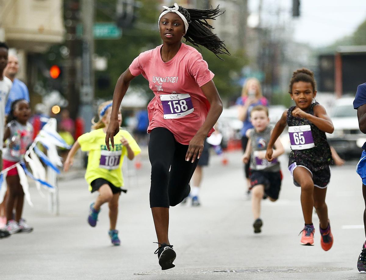 Ayanna Darrington, 12, wins the in the overall winner’s race and was named the Fastest Kid in Town for the second year   in a row Saturday in downtown Lexington.