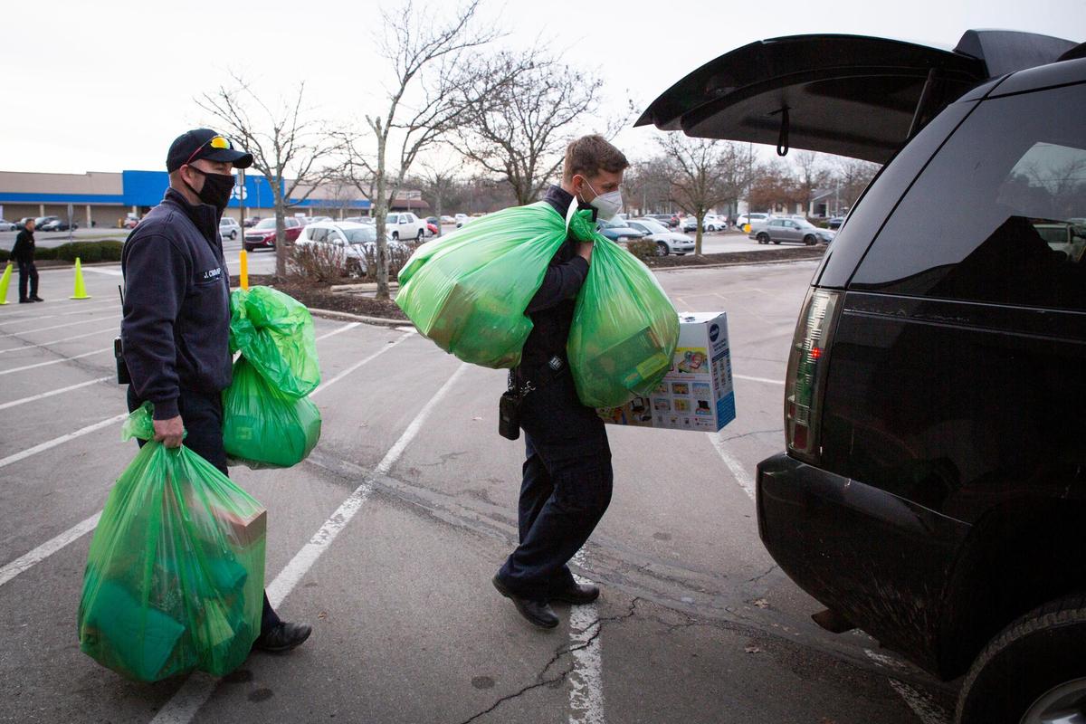 Firefighters helped load a car with gifts during the Salvation Army Angel Tree distribution on Dec. 18.