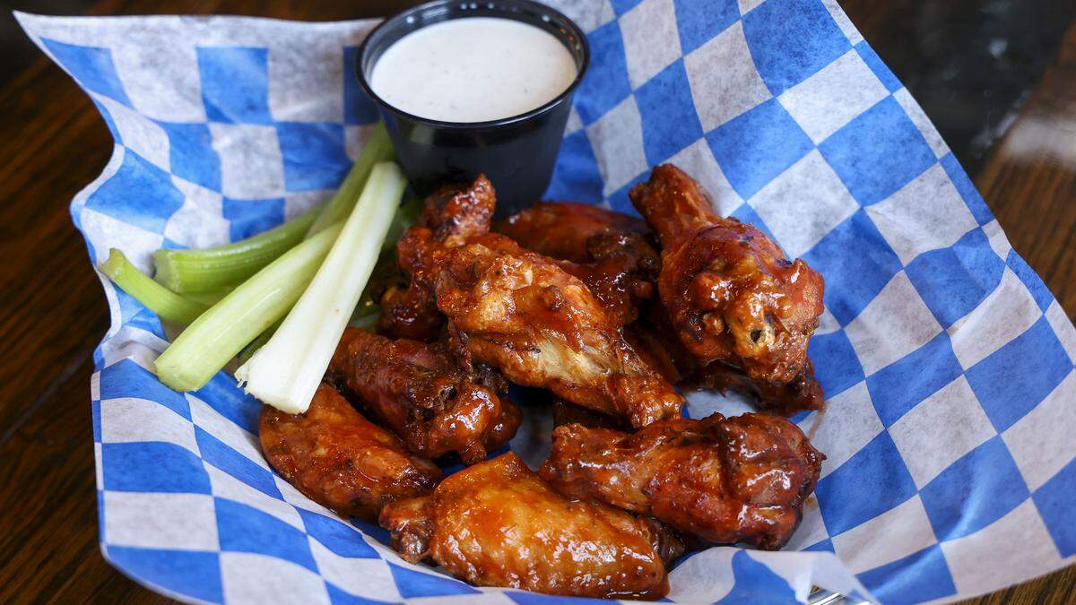 Smoked chicken wings with medium sauce from KSBar & Grille in Lexington, Ky., photographed Thursday, Aug. 28, 2025.