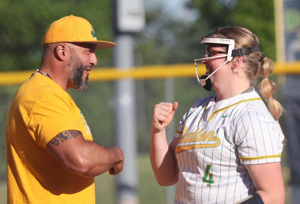 Brian Station coach Hector Urbaneja congratulated pitcher Karsyn Rockvoan after she marked the 1,000th strikeout of her career during the Defenders’ game against Frederick Douglass at Bryan Station on May 9, 2025.