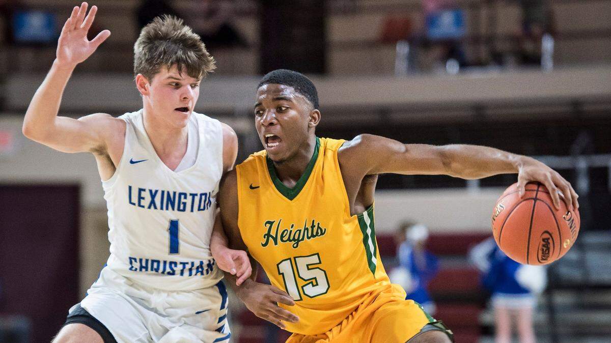 University Heights Academy’s Dekeyvan Tandy drives the ball up court against LCA’s Baylor Brown, during the finals of the boys All-A Classic, Sunday, January 27, 2019, at EKU’s McBrayer Arena in Richmond.