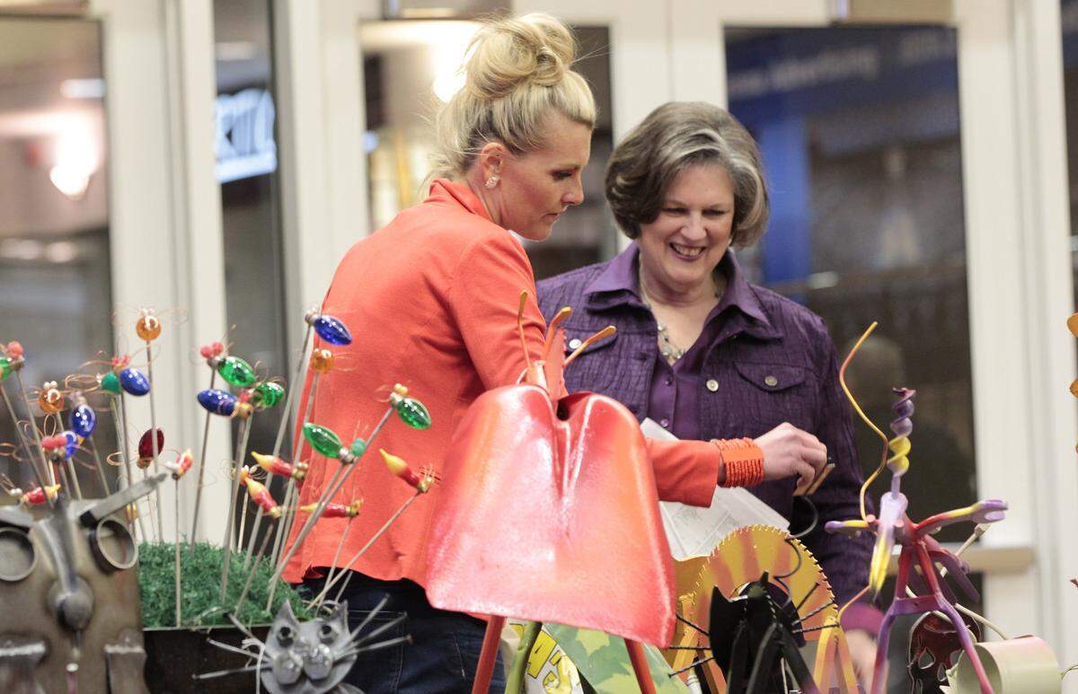Leslie Salisbury, left and her mother-in-law, Holly Salisbury looked at metal sculptures by Flashback Steel Art at the Central Kentucky Home, Garden and Flower Show at the Lexington Center in Lexington, Ky., on April 13, 2012.