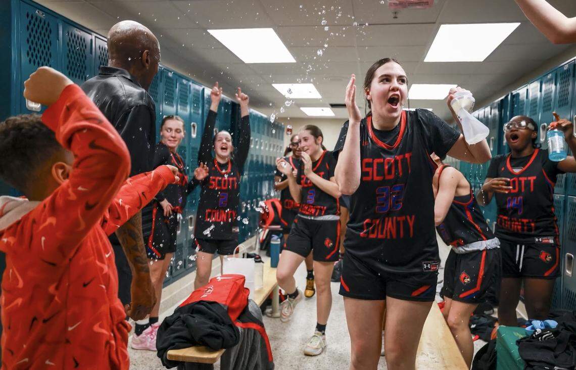 The Scott County Cardinals celebrated their 40-33 win over Bryan Station with a water bottle shower in the locker room after the girls 42nd District Tournament semifinals at Bryan Station High School on Wednesday.