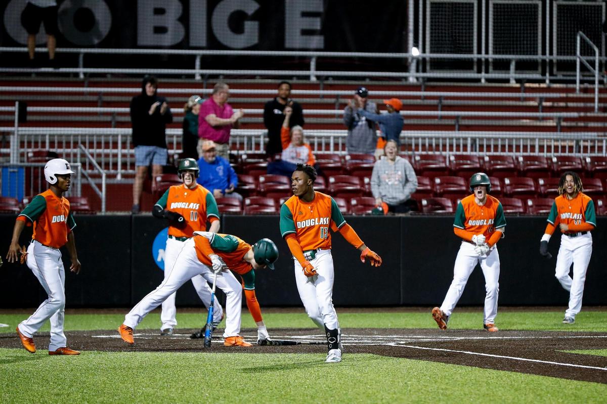 Ty Bryant (13) celebrates with his Frederick Douglass teammates after hitting an inside-the-park grand slam against Henry Clay.