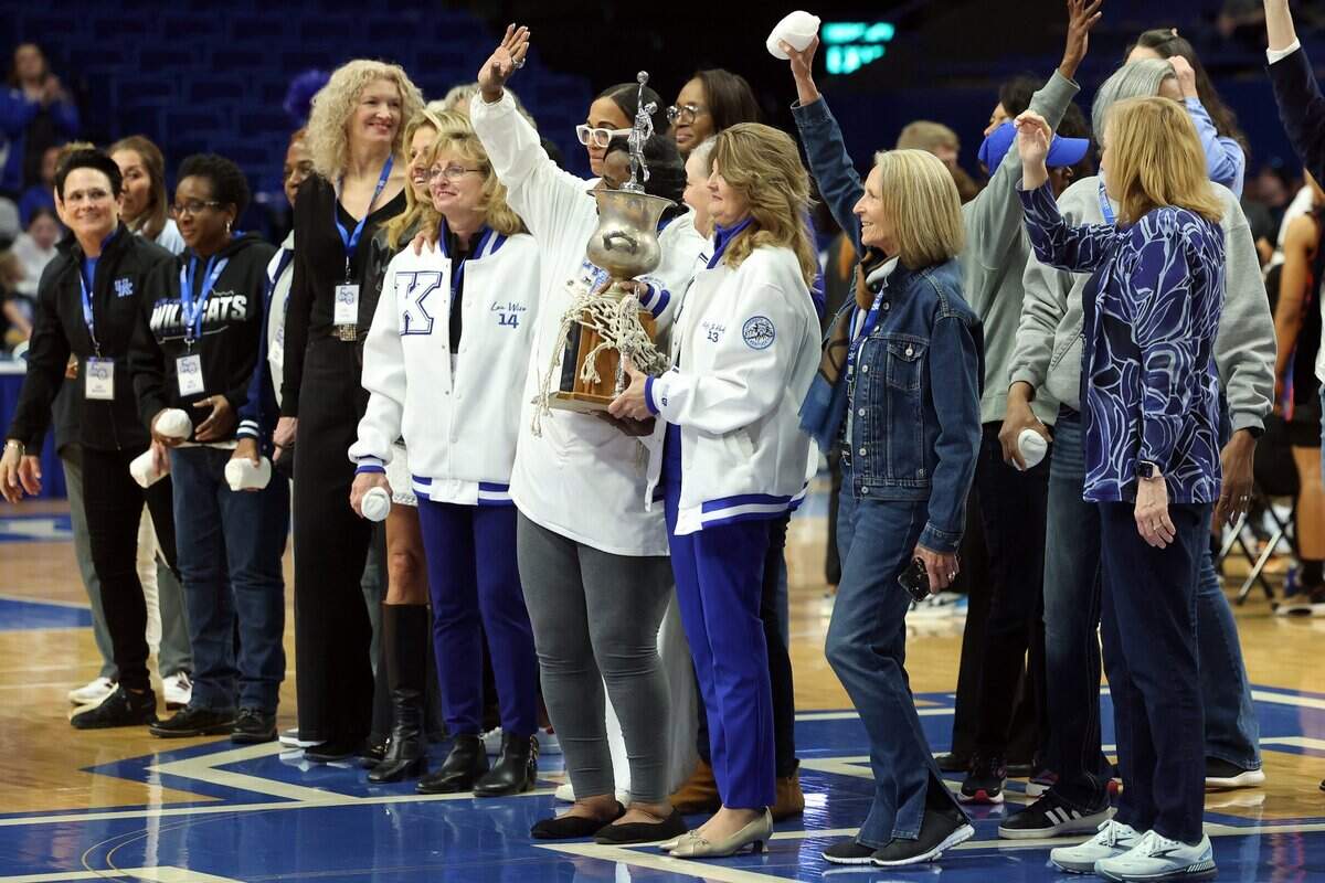Kentucky alumni from the 1980s are celebrated on the court during Sunday’s game against Florida at Rupp Arena.