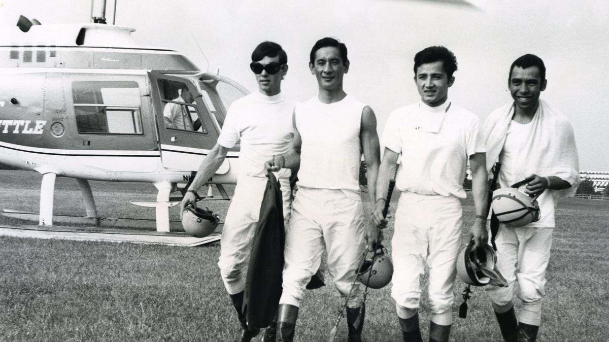 Jockeys (left to right) Eddie Belmonte, Braulio Baeza, Jacinto Vásquez, and Ángel Cordero Jr. make their entrance at Monmouth Park Racetrack in Oceanport, N.J. in July 1969, taking a helicopter from New York to the track.