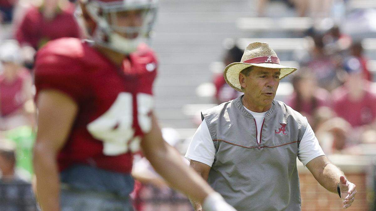 Alabama head coach Nick Saban, right, announces drills to players during practice at Bryant–Denny Stadium on Aug. 5, 2017. Saban has been miked up this summer for an all-access ESPN series that will begin airing Aug. 9.