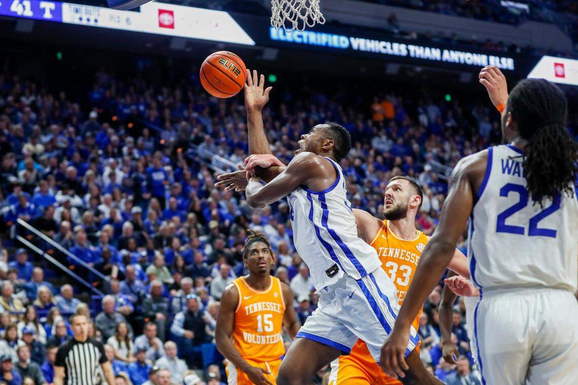 Kentucky’s Oscar Tshiebwe (34) is fouled by Tennessee’s Uros Plavsic (33) while driving to the basket during Saturday’s game at Rupp Arena.