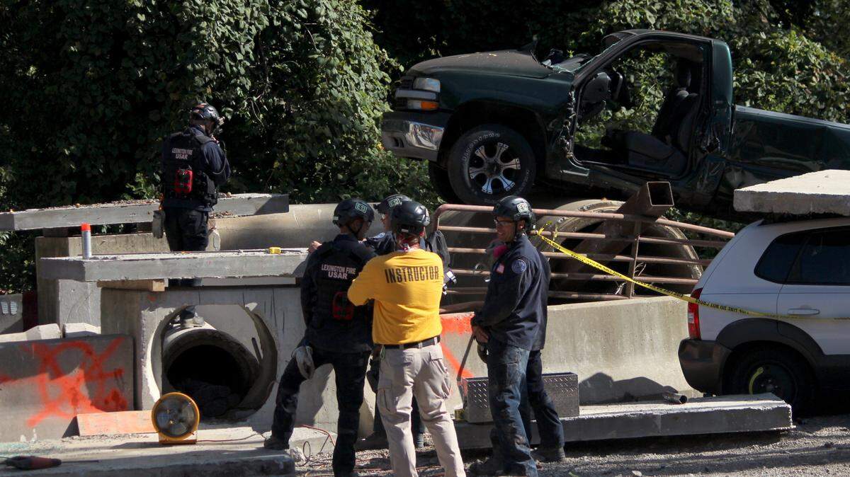 Trainees participating in a structural collapse training course listen to pointers from an instructor during a total structural collapse demonstration at the Lexington Fire Department training facility on Sept. 29, 2022.