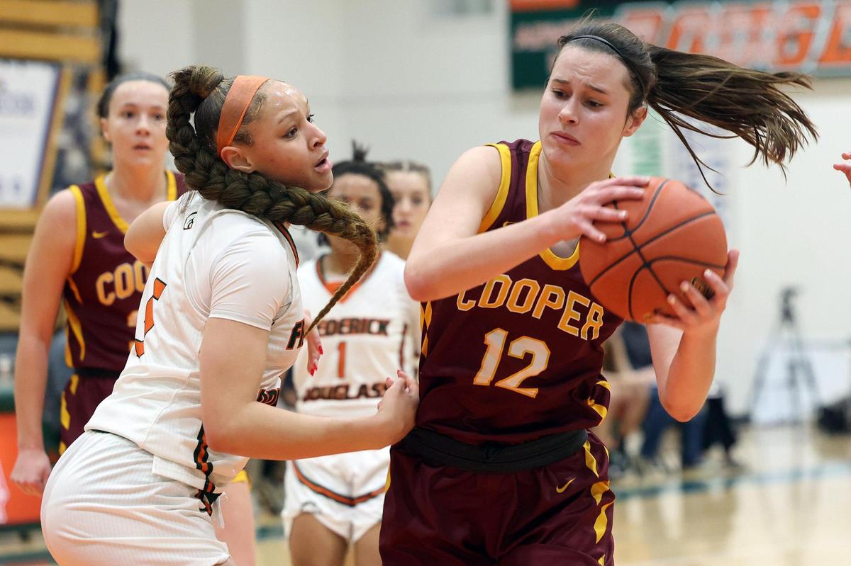 Cooper’s Whitney Lind (12) is pressured by Frederick Douglass’ Victory Sledge during Friday’s game in Lexington. Cooper won 68-56.