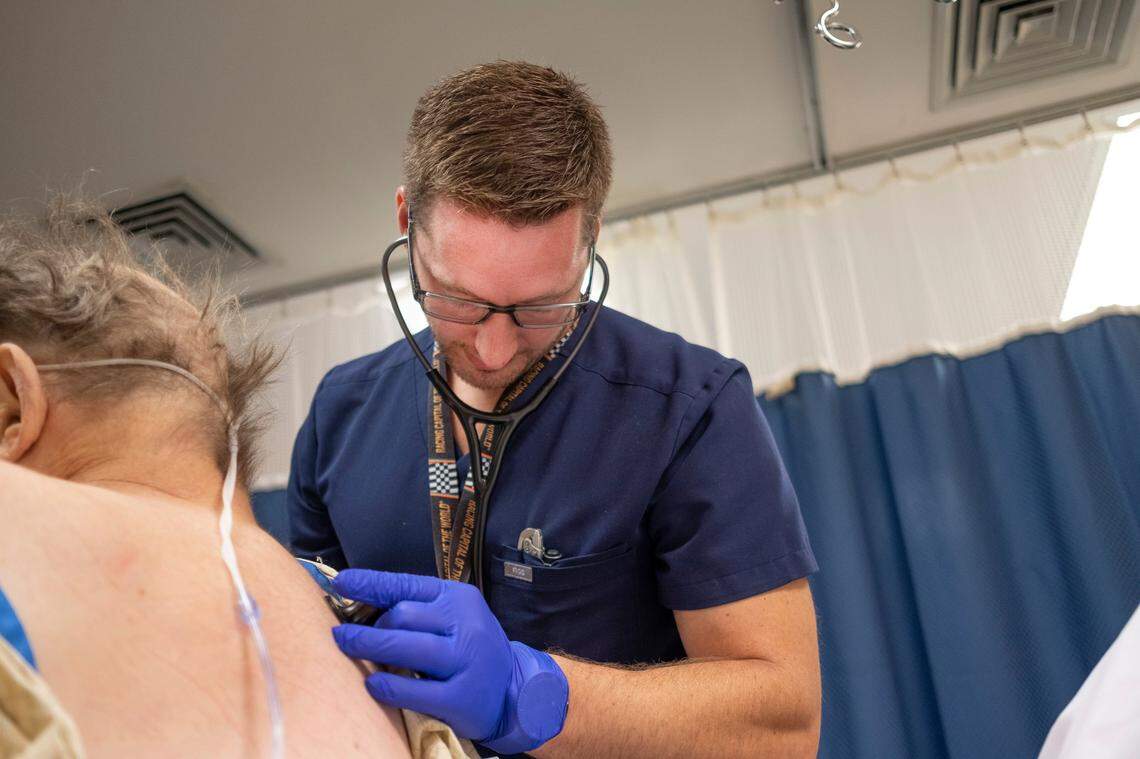 Dr. Philip Overall examines a patient in the emergency room at St. Claire Hospital.