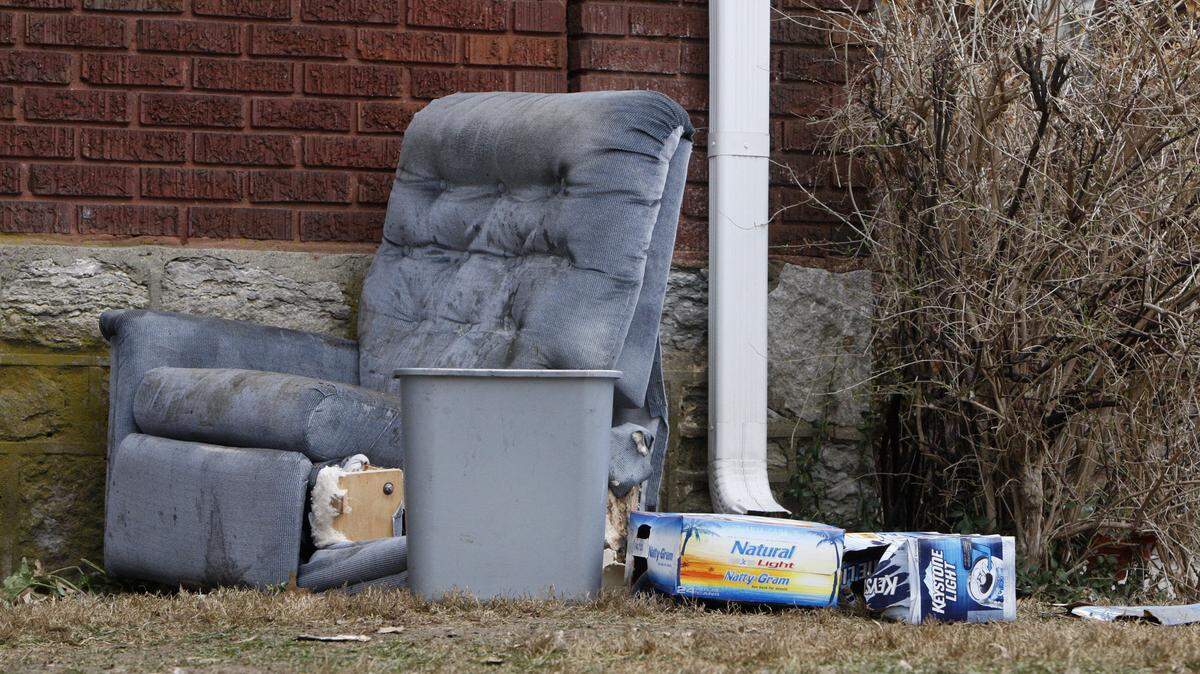 Discarded recliner and beer cases at 202 State St. where a sofa was burned during a night of partying as UK fans celebrated the team's win over UofL in the NCAA Tournament in Lexington, Ky., Saturday, March 29, 2014. Photo by Matt Goins