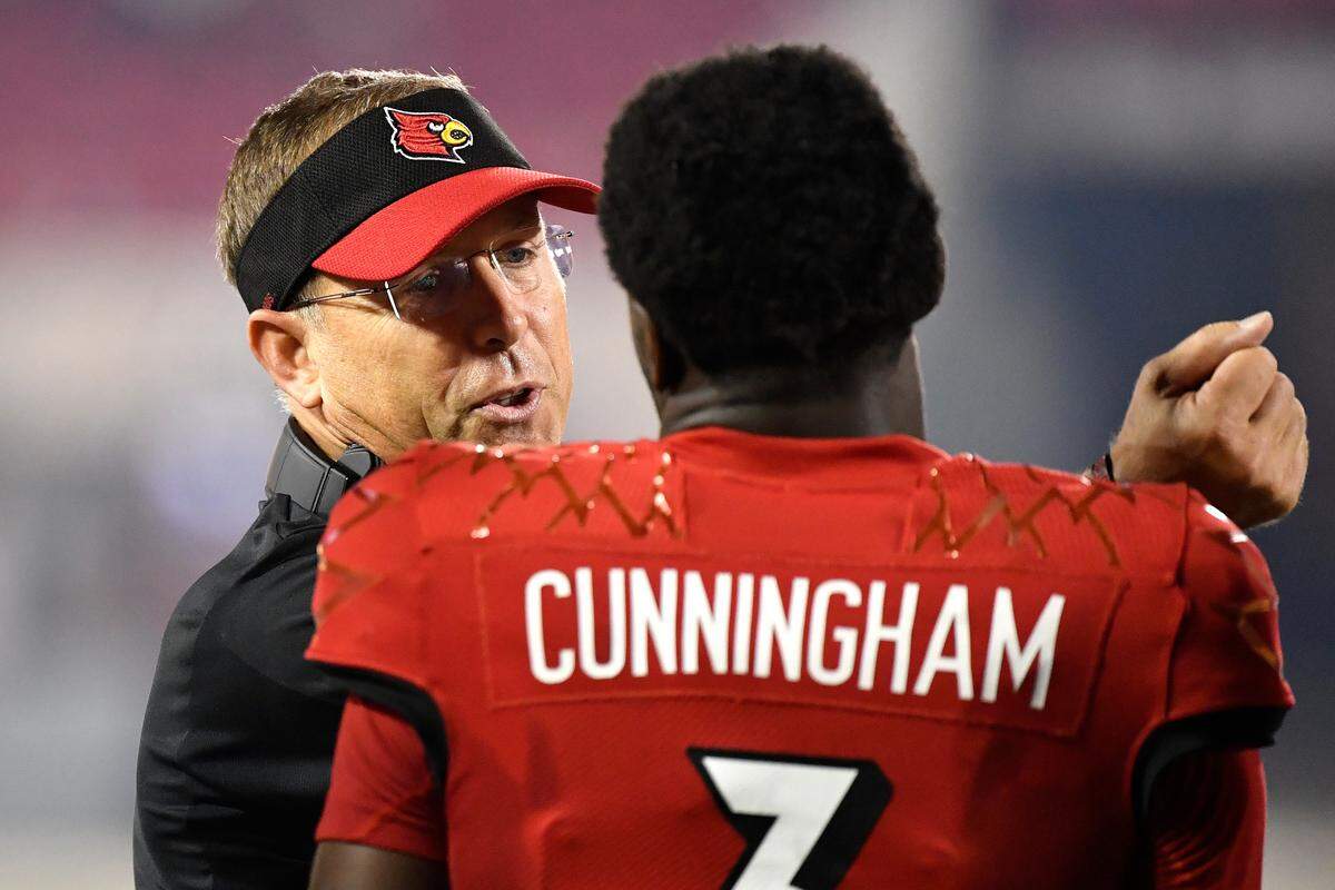 Louisville head coach Sott Satterfield, left, talked with quarterback Malik Cunningham during the team’s win against Eastern Kentucky on Sept. 11.