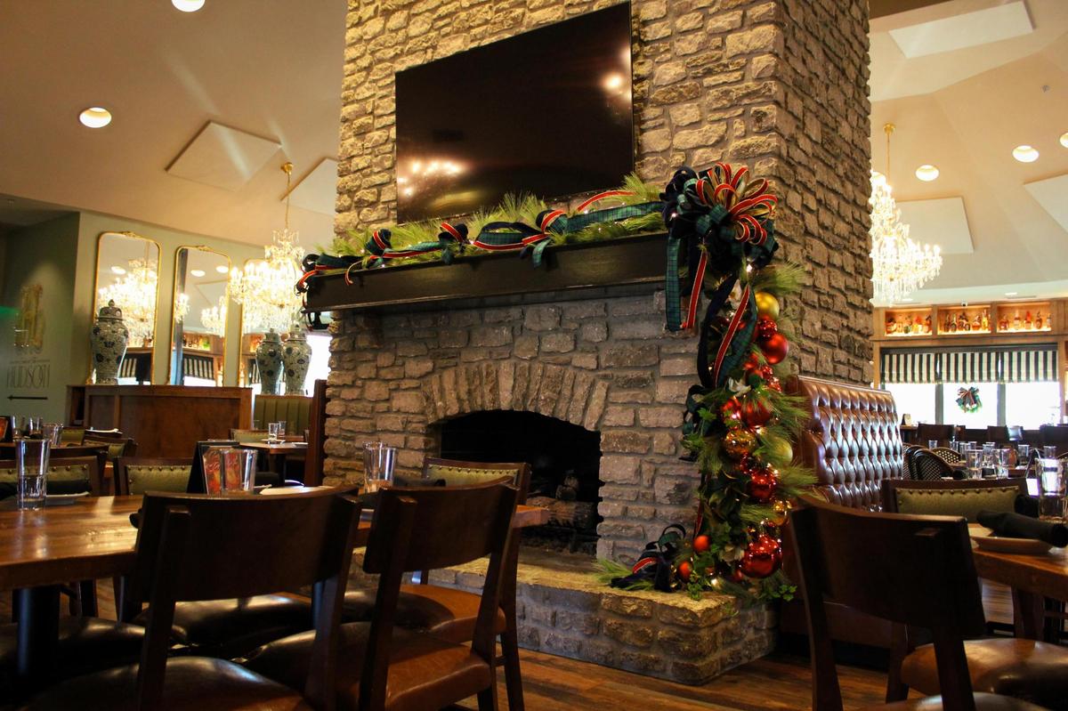 Holiday decorations drape a fireplace in the main dining room at Carson’s Food & Drink at Andover location.
